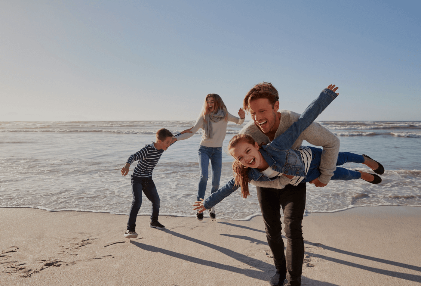 Family of four playing on a beach