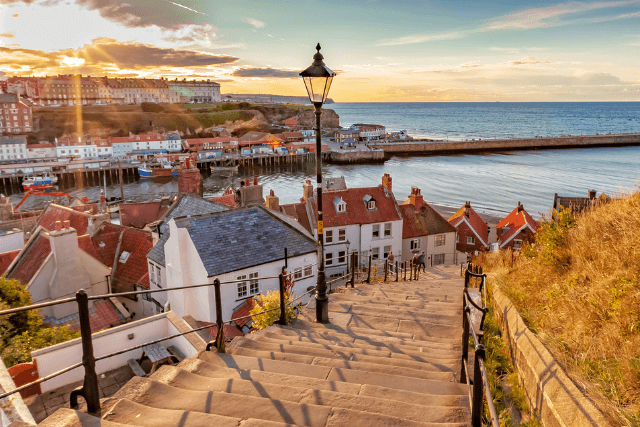 Sunset over the famous 199 steps at Whitby, North Yorkshire Coast, England, UK