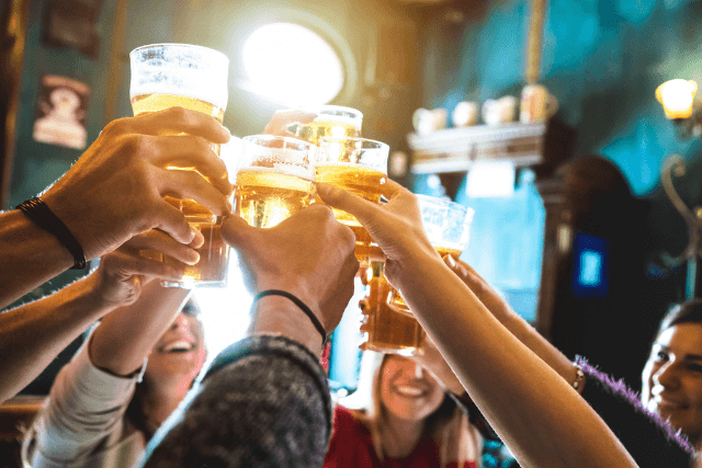 Group of people saying cheers in a Whitby pub