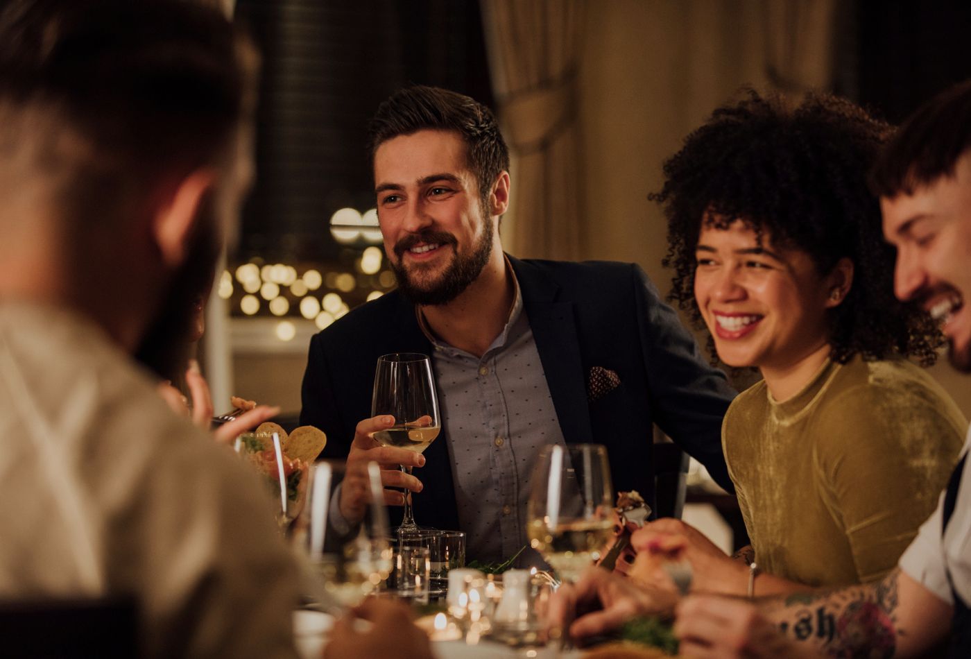 A couple enjoying a meal and glass of wine in a restaurant