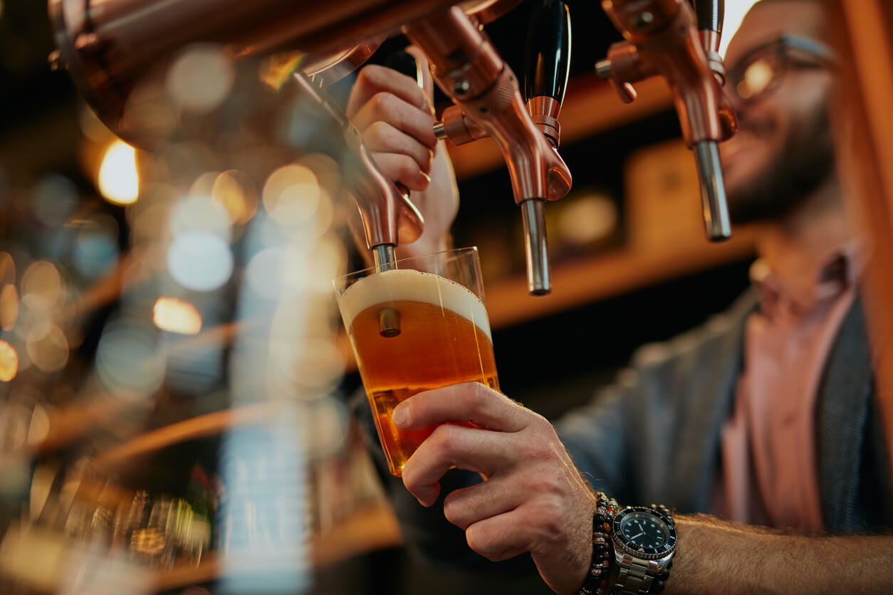 Man pouring pint.