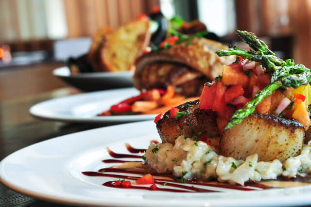 A fish dish sat on a plate in a restaurant