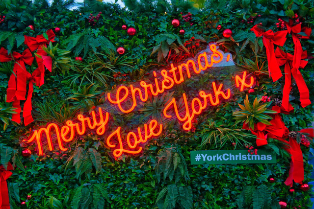 A red neon sign that says Merry Christmas Love York