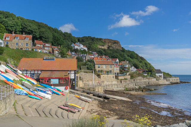 A shot of Runswick Bay Beach, houses and kayaks