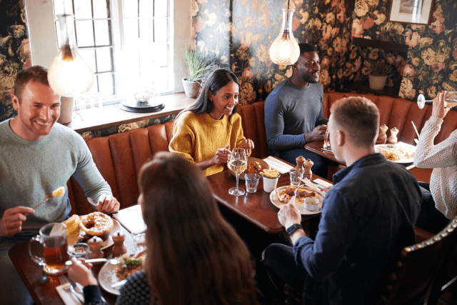 People enjoying a meal in a cosy pub in Scarborough.