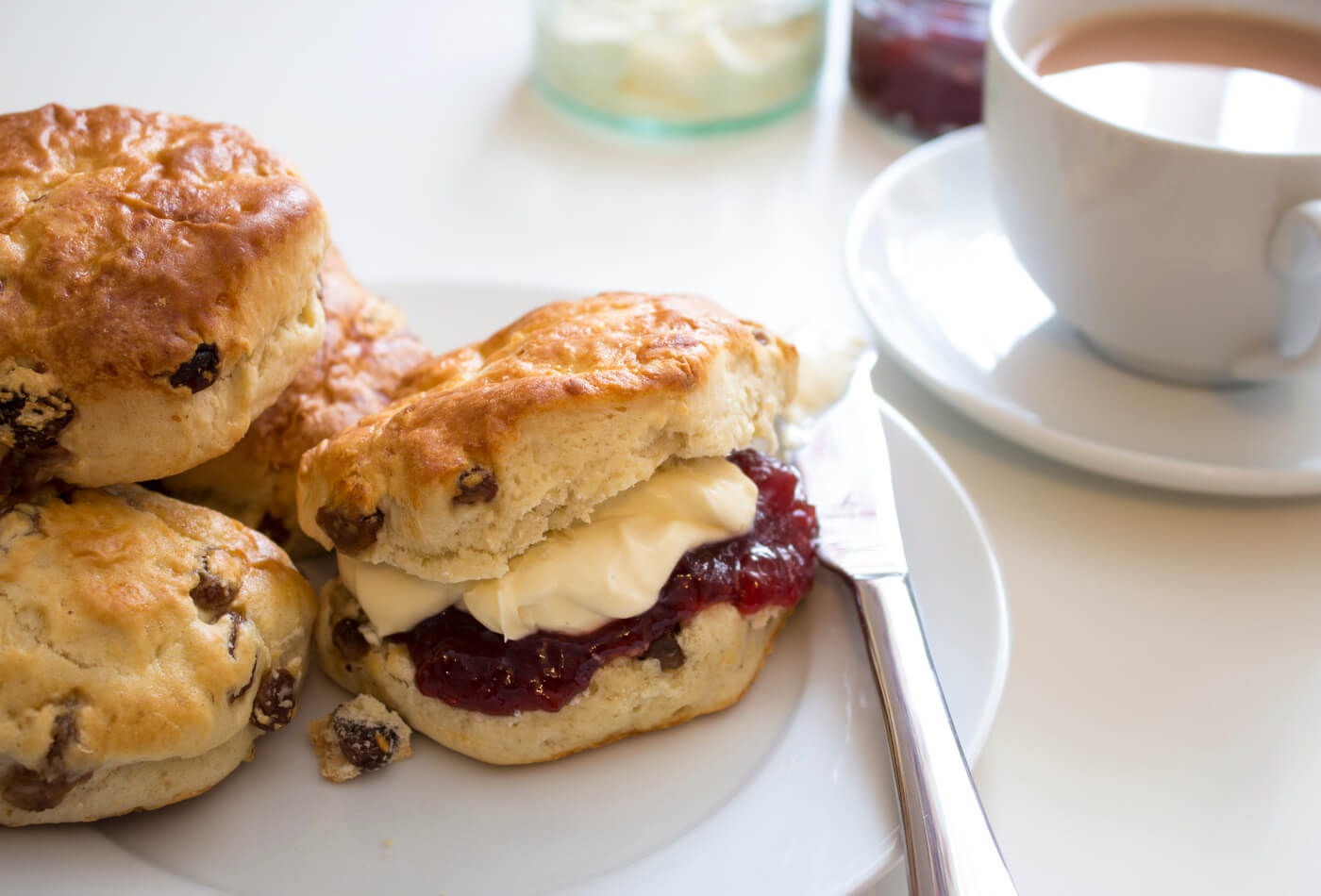 Scones with jam and cream on a plate