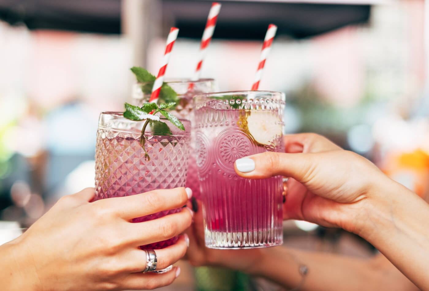 A group of friends toasting cocktails glasses