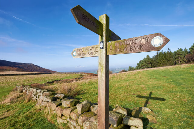 A signpost for the Cleveland Way pointing in four directions