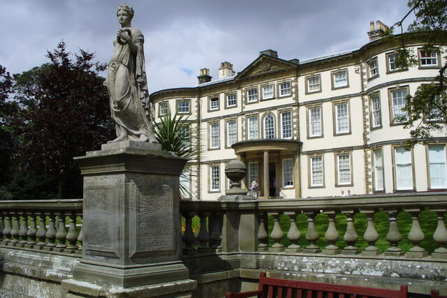 An external shot of Sewerby Hall and the statue in front