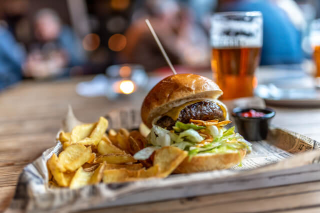 A burger and chips on a tray in a restaurant