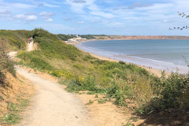 A sandy coastal path running alongside the beach in Filey