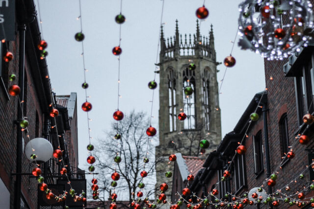 Baubles hanging from buildings in York at Christmas