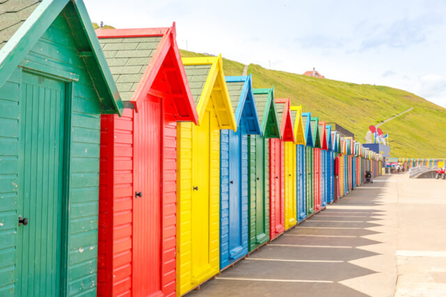 Colourful beach huts lining the promenade