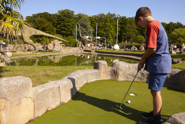 A young child playing Jurassic Adventure Golf at Lightwater Valley